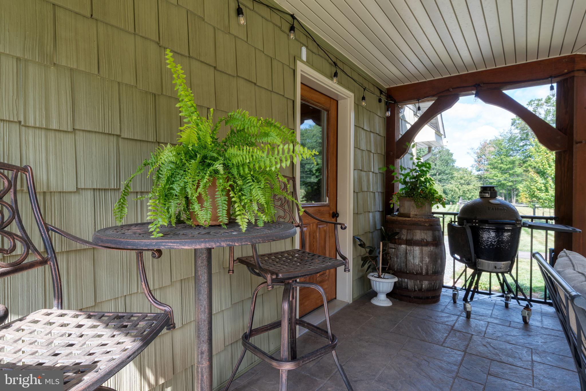 5382 Paes Road New Holland, PA 17557 - Photo 47 of 80 a patio with table and chairs and potted plants