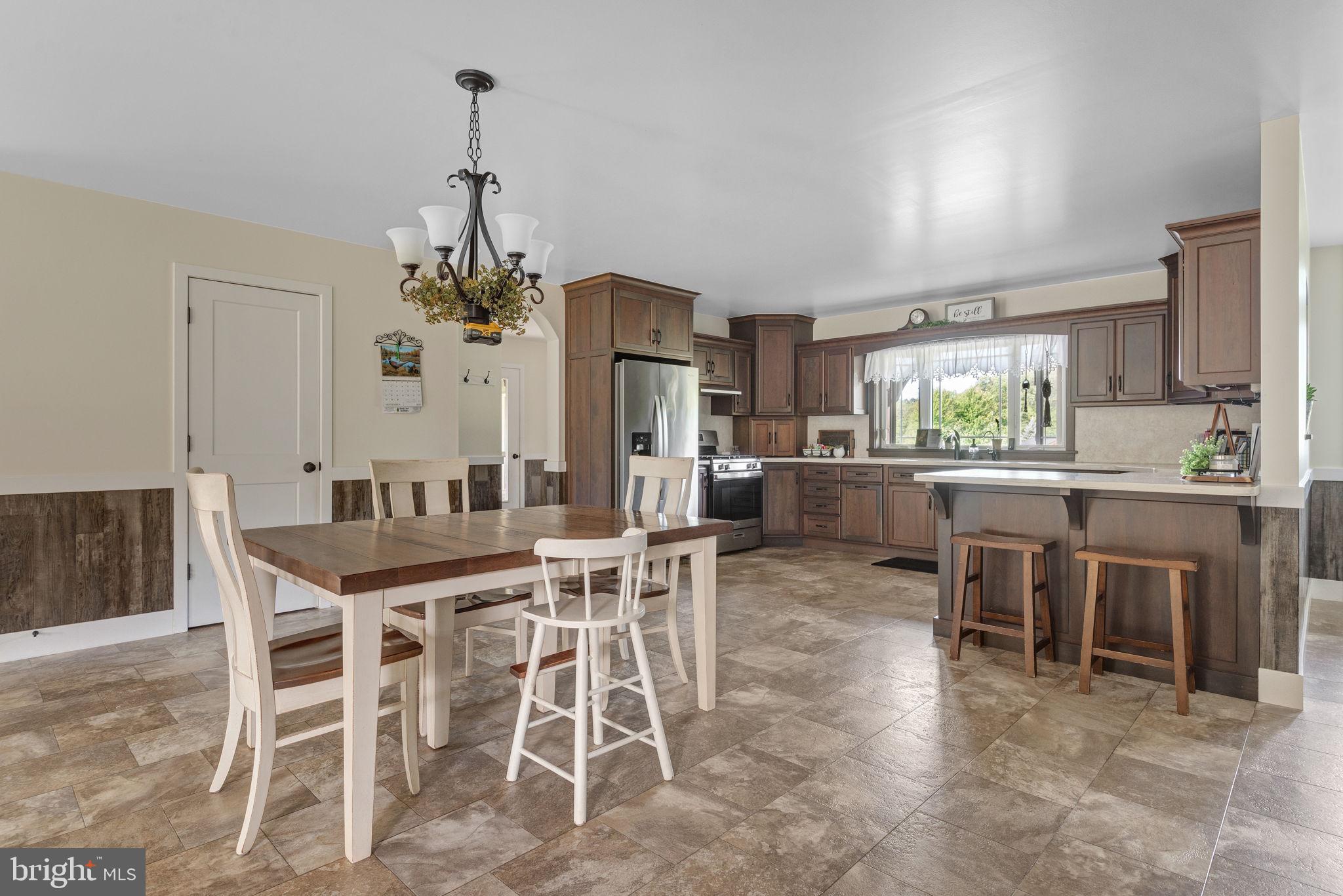 5382 Paes Road New Holland, PA 17557 - Photo 10 of 80 a dining room with furniture a chandelier and kitchen view