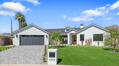 a front view of house with a garden and patio