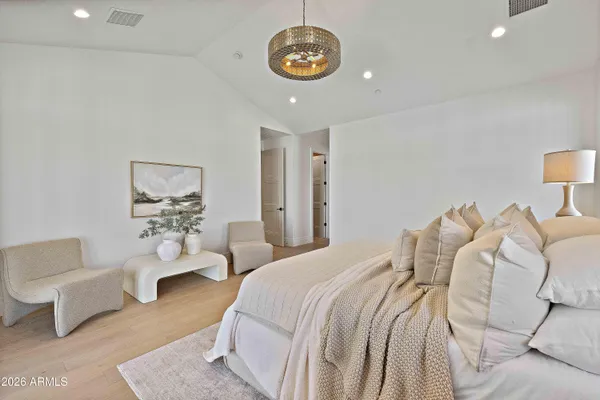 a bedroom with furniture and a large mirror