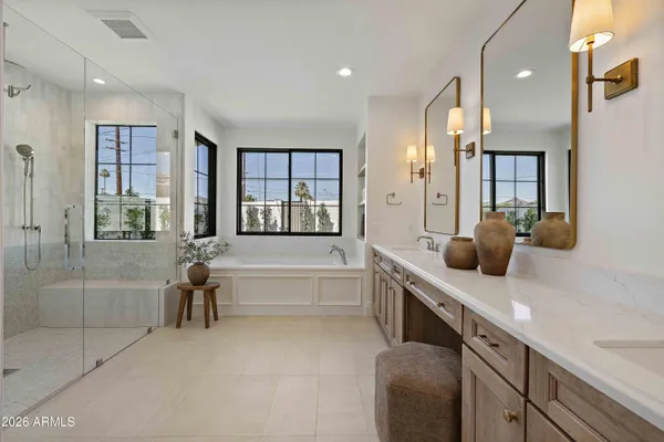 a bathroom with a tub sink and mirror