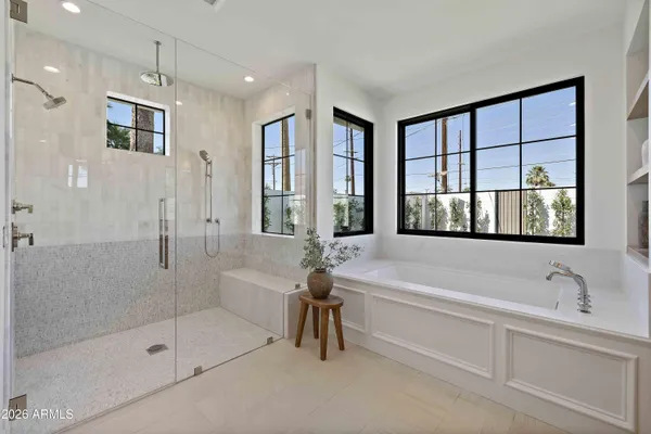 a spacious bathroom with a tub shower and sink