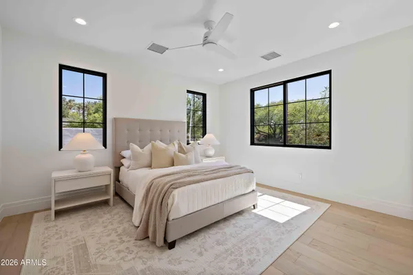 a spacious bedroom with a bed and a window