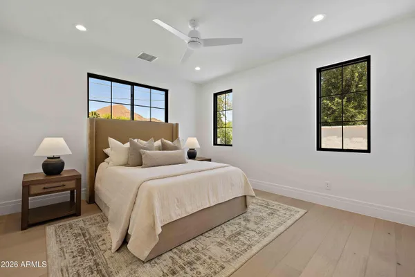 a bedroom with a large bed and a window
