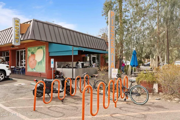 a front view of a house with basket ball table and chairs
