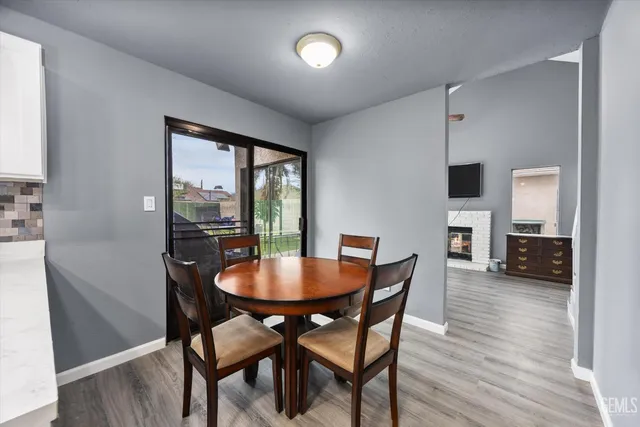 a dining room with furniture window and wooden floor
