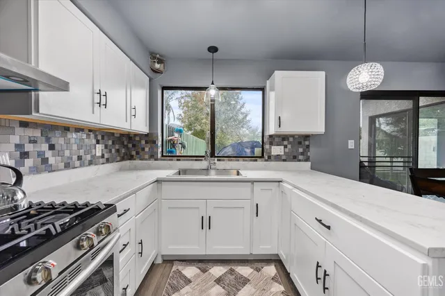 a kitchen with a sink stove and cabinets