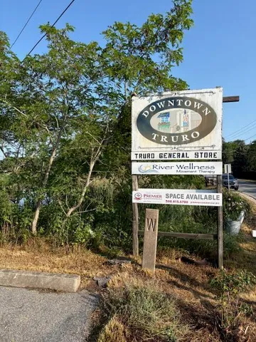 a view of a wooden bench with a small yard