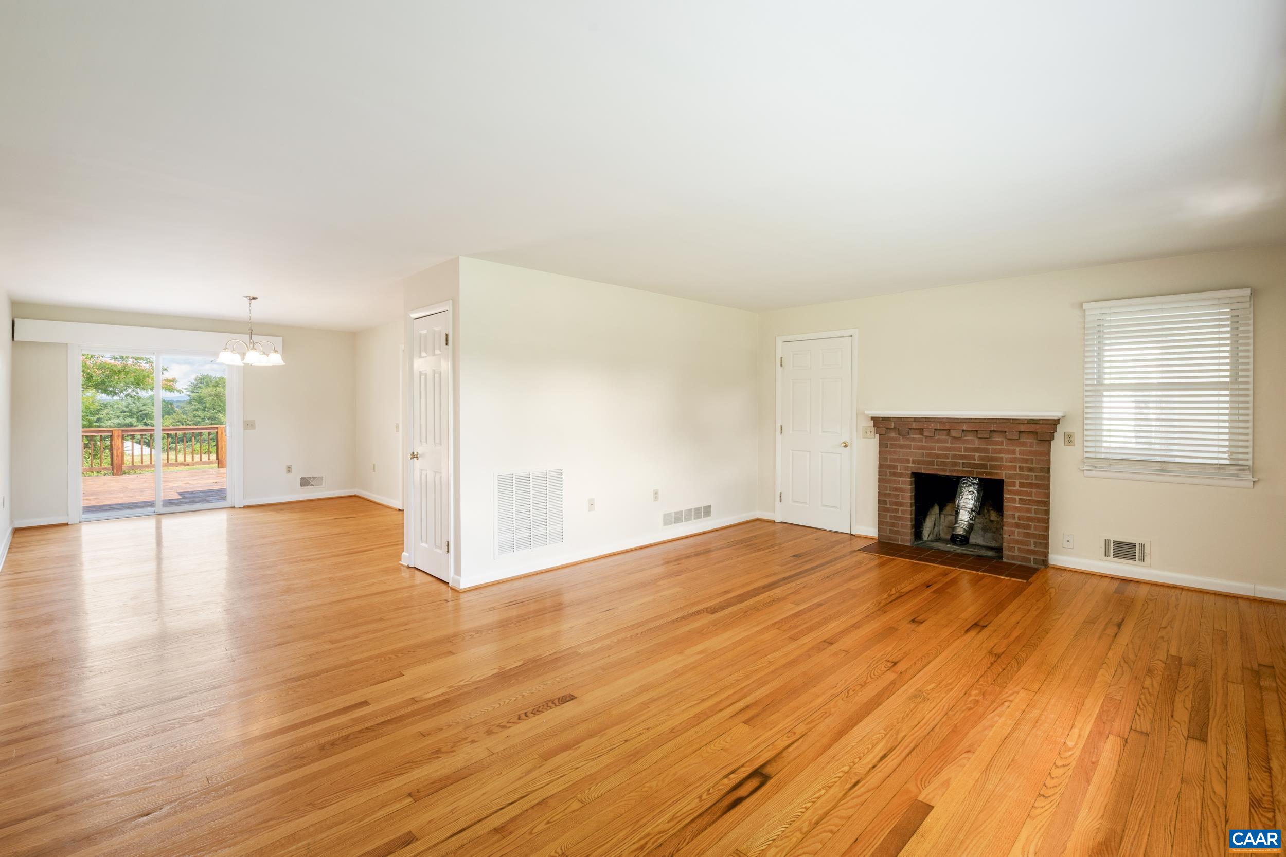 1293 Reas Ford Road Earlysville, VA 22936 - Photo 11 of 38 a view of an empty room with wooden floor fireplace and a window