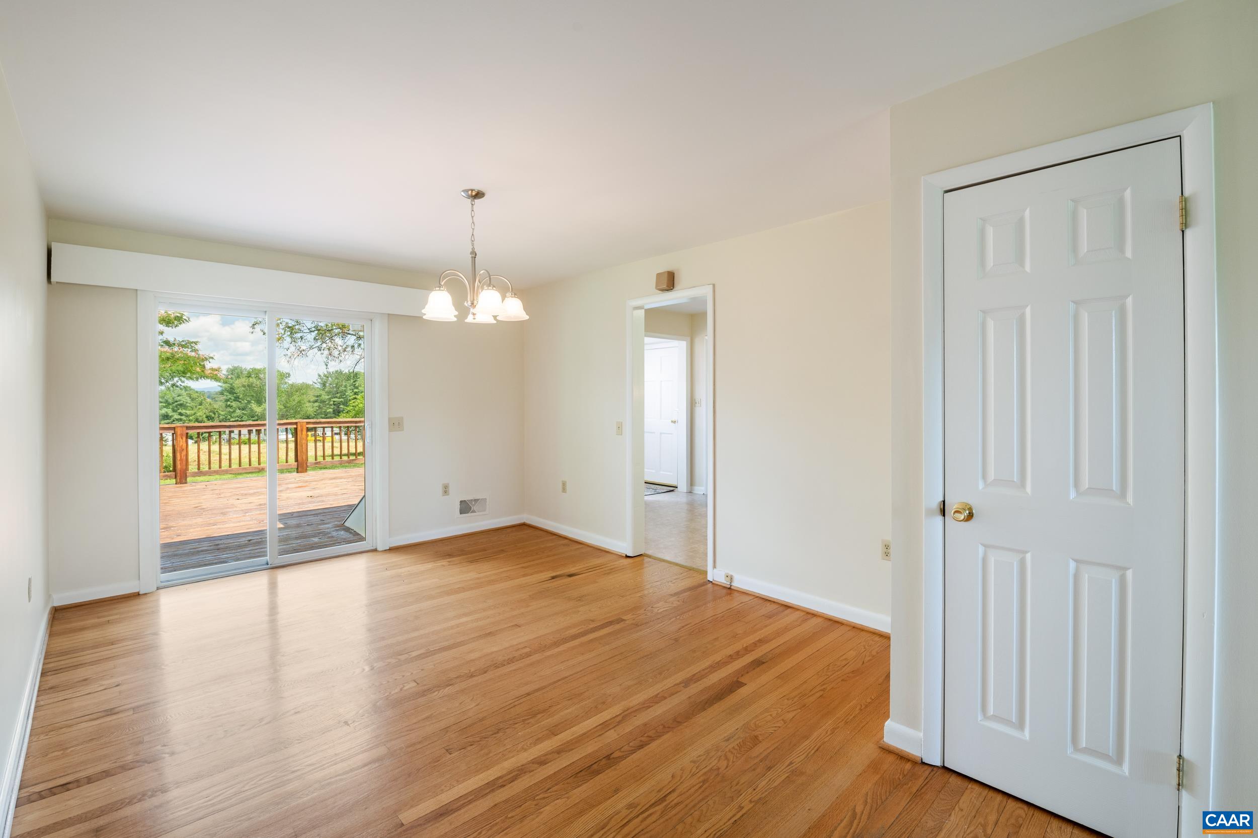 1293 Reas Ford Road Earlysville, VA 22936 - Photo 12 of 38 a view of an empty room with wooden floor and a window