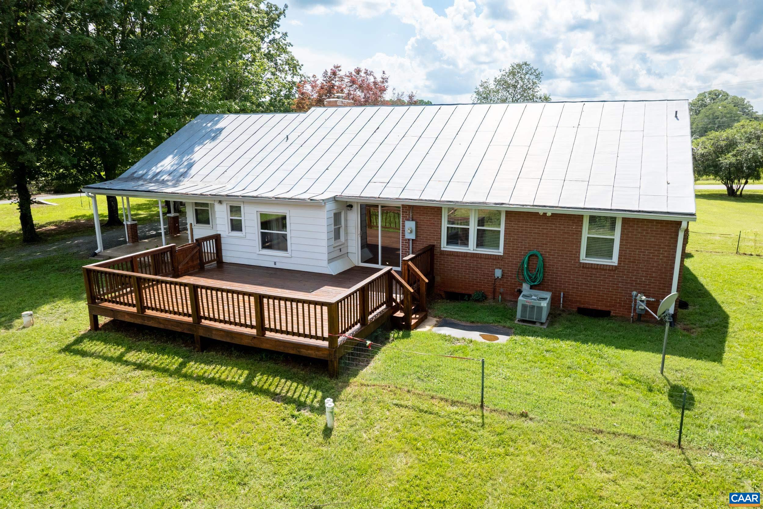 1293 Reas Ford Road Earlysville, VA 22936 - Photo 2 of 38 a backyard of a house with yard and outdoor seating