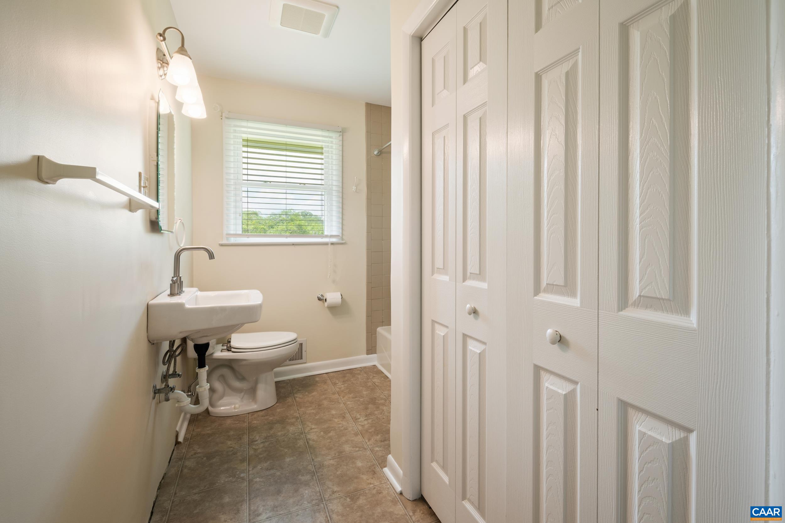 1293 Reas Ford Road Earlysville, VA 22936 - Photo 27 of 38 a bathroom with a sink a toilet and a window