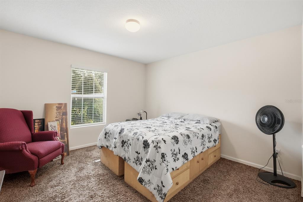 123 Fairway Court Bunnell, FL 32110 - Photo 13 of 22 a bedroom with a bed a couch and a window