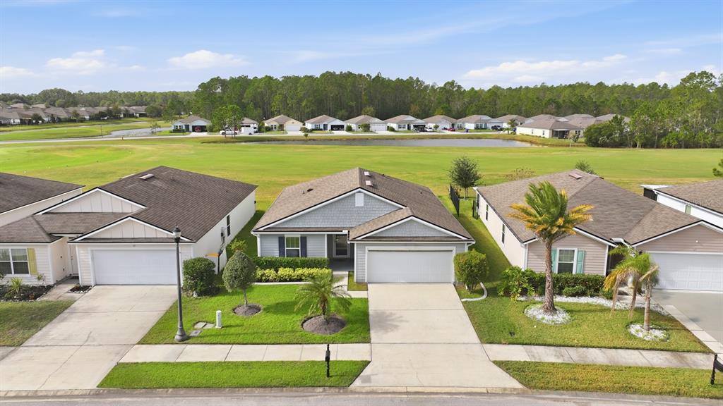 123 Fairway Court Bunnell, FL 32110 - Photo 20 of 22 a aerial view of a house with big yard and large trees