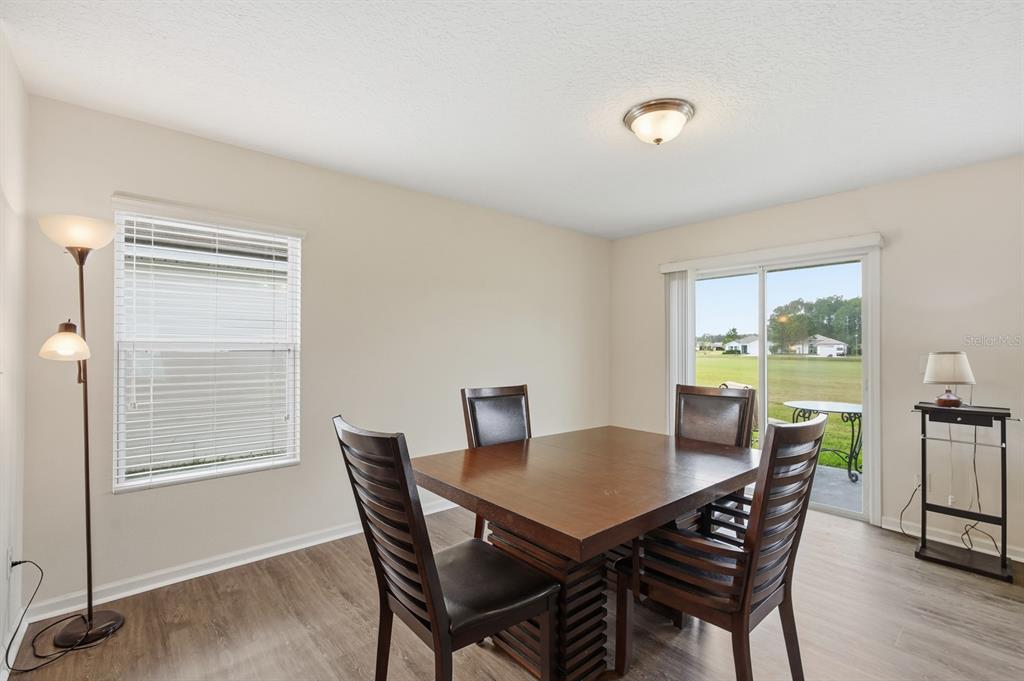 123 Fairway Court Bunnell, FL 32110 - Photo 8 of 22 a view of a dining room with furniture and wooden floor
