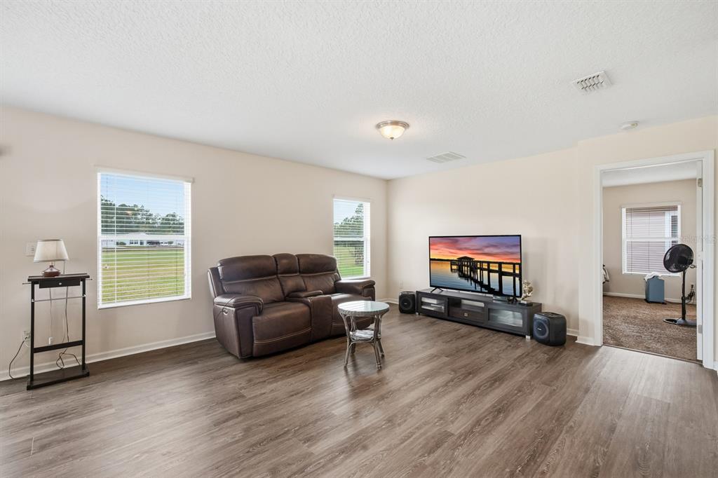 123 Fairway Court Bunnell, FL 32110 - Photo 9 of 22 a living room with furniture and a flat screen tv