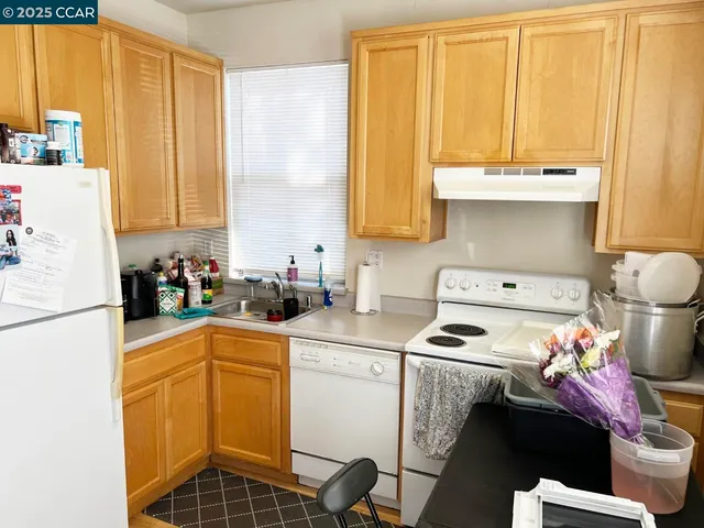 a view of balcony with two potted plants and wooden floor