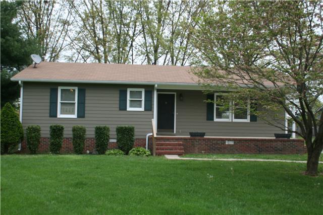1432 Riley Creek Road Tullahoma, TN 37388 - Photo 1 of 7 a backyard of a house with table and chairs