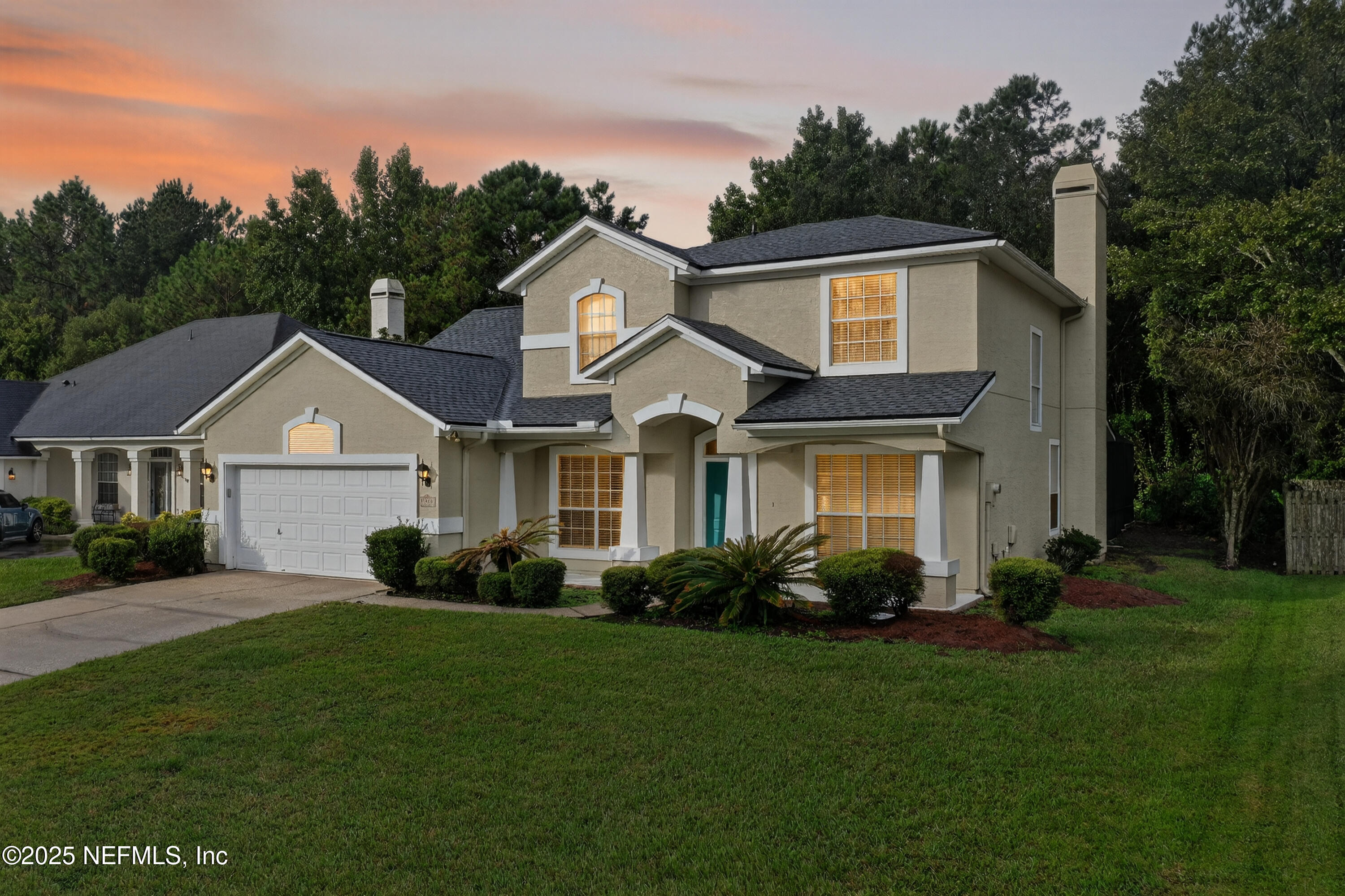 1908 Tuscan Oaks Court Fleming Island, FL 32003 - Photo 1 of 33 a front view of a house with a garden and plants