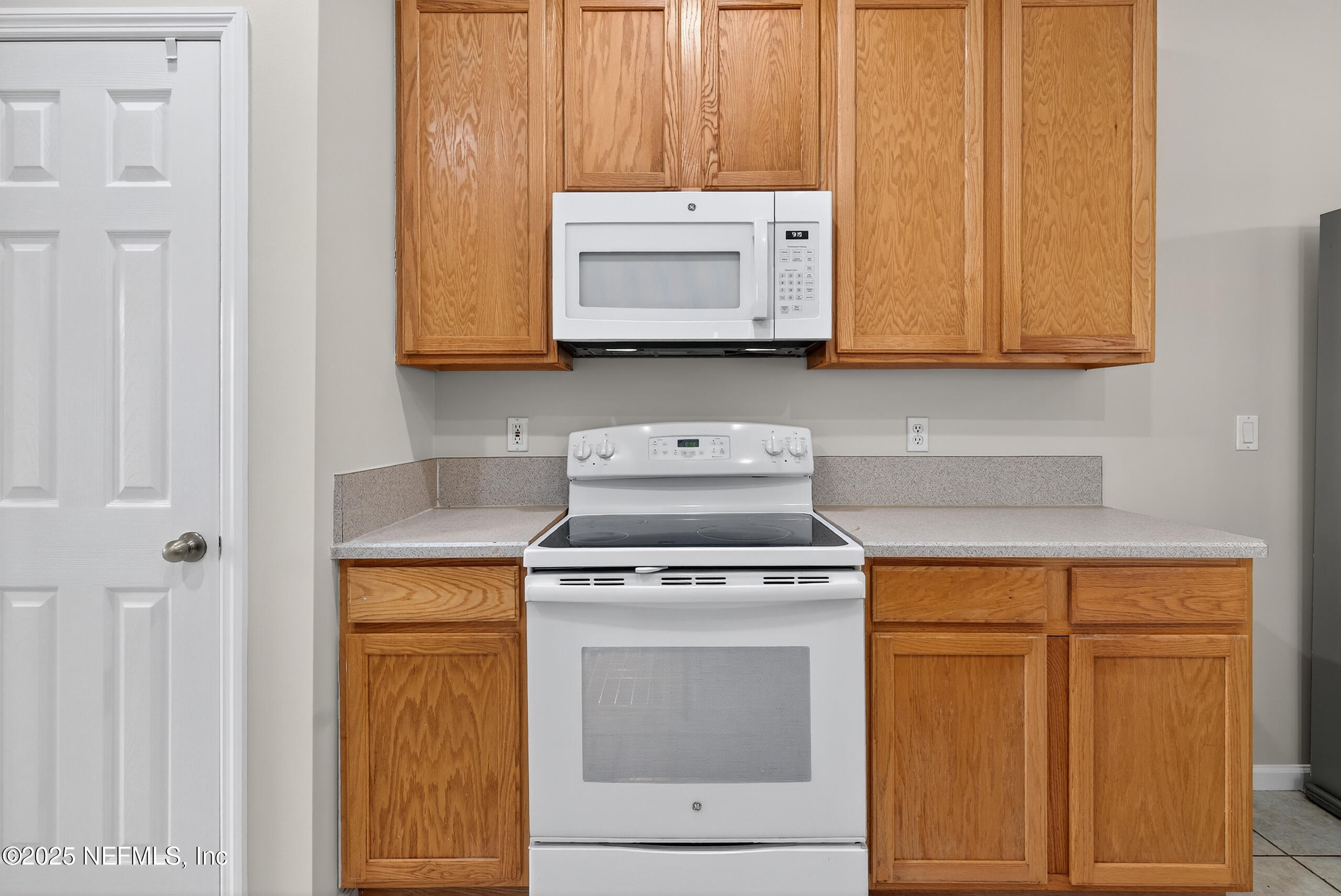 1908 Tuscan Oaks Court Fleming Island, FL 32003 - Photo 12 of 33 a stove top oven sitting inside of a kitchen