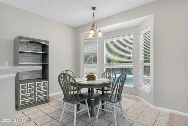 a living room with furniture and a dining table