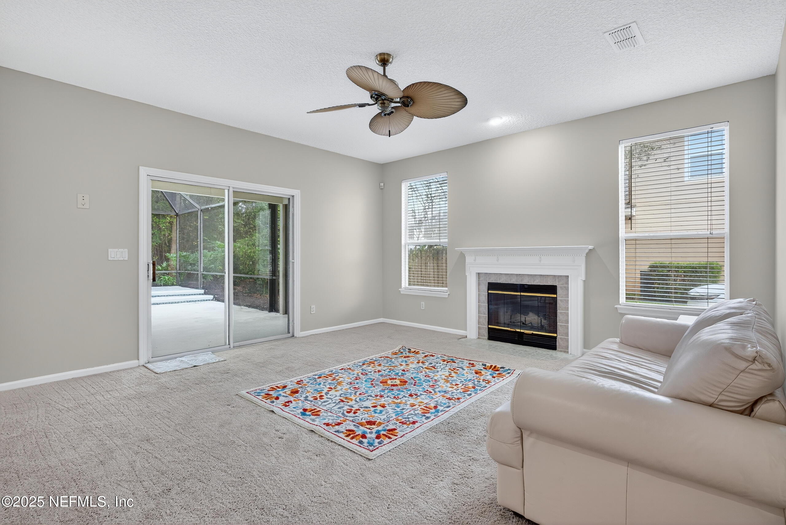 1908 Tuscan Oaks Court Fleming Island, FL 32003 - Photo 15 of 33 a living room with furniture and a fireplace