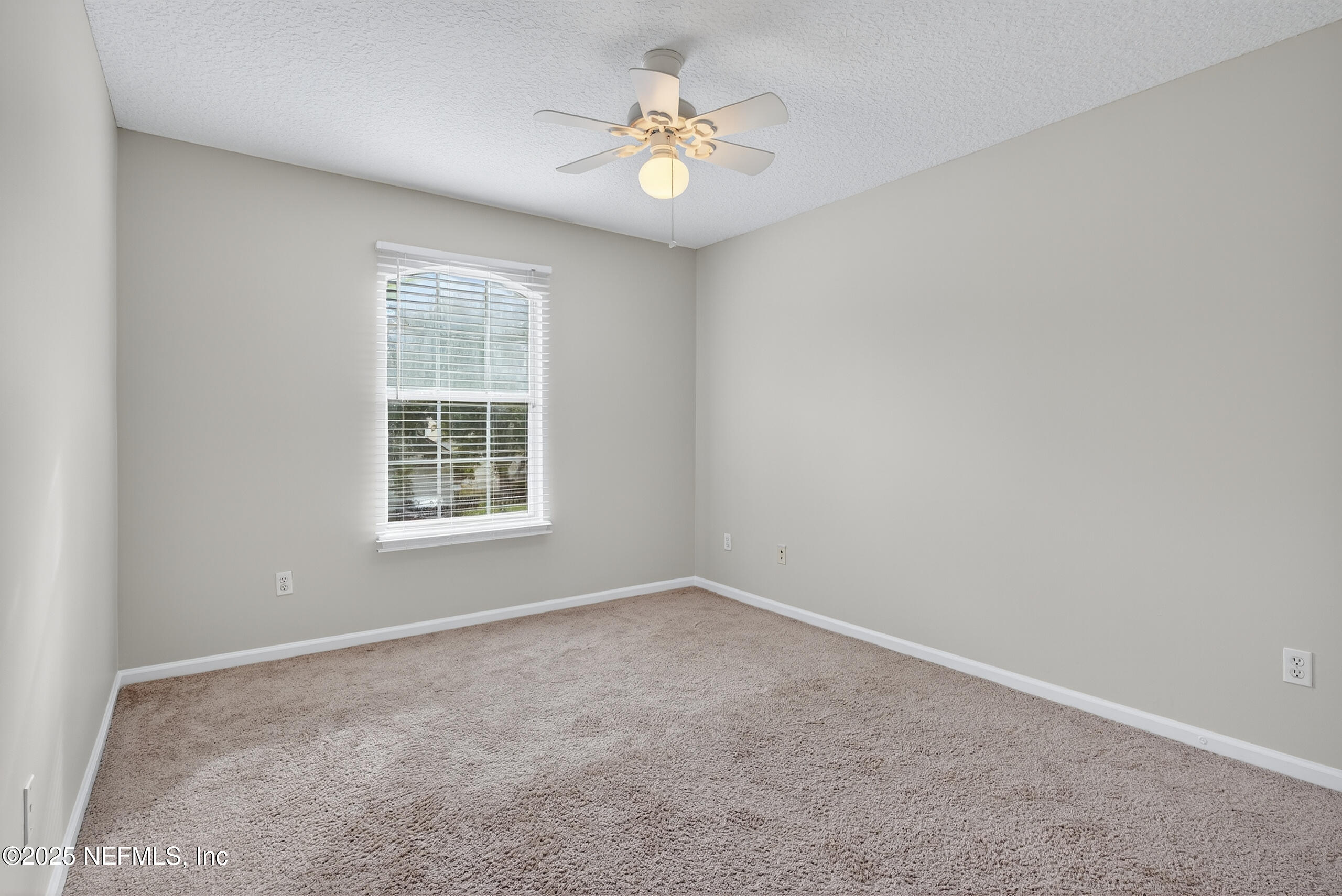 1908 Tuscan Oaks Court Fleming Island, FL 32003 - Photo 27 of 33 an empty room with a window and a fan