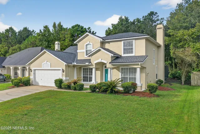 a front view of a house with a garden and plants