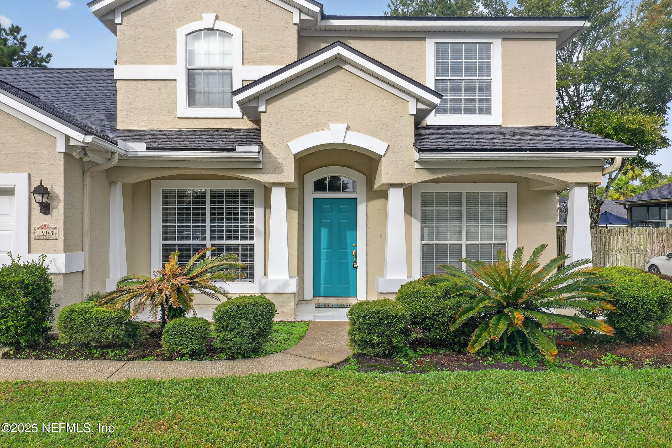 1908 Tuscan Oaks Court Fleming Island, FL 32003 - Photo 5 of 33 a front view of a house with a garden and plants