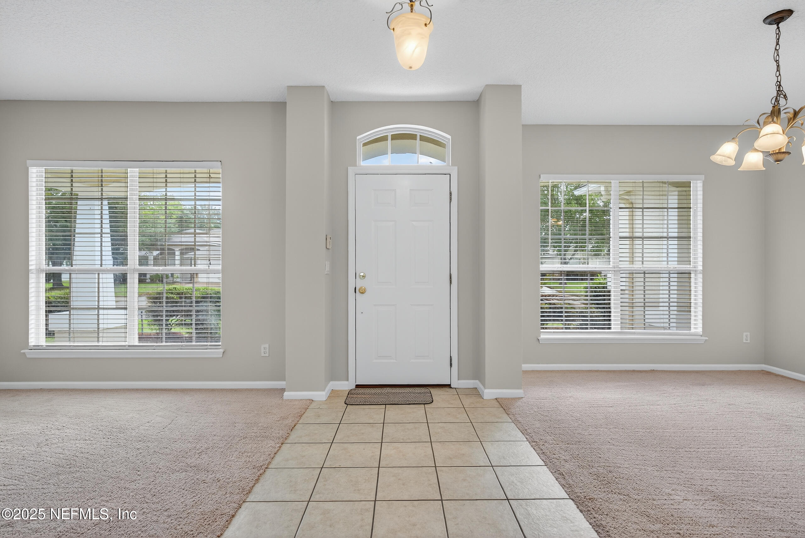 1908 Tuscan Oaks Court Fleming Island, FL 32003 - Photo 9 of 33 an empty room with windows and entrance