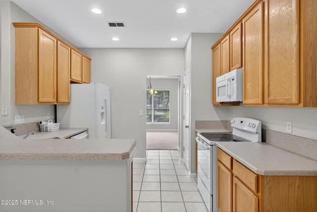 a stove top oven sitting inside of a kitchen