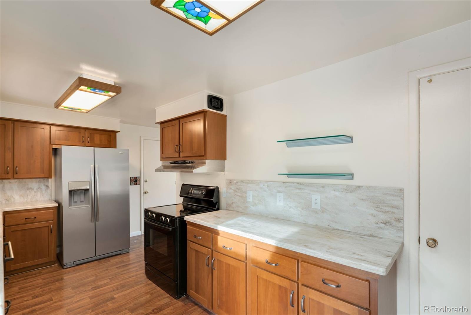 7101 Beach Street Westminster, CO 80030 - Photo 6 of 18 a kitchen with refrigerator cabinets and a counter top space
