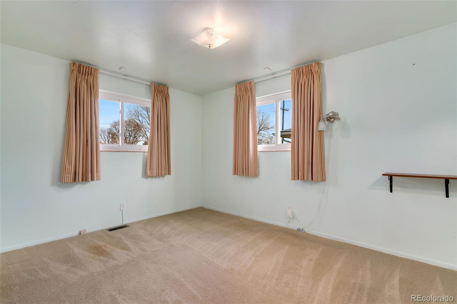 7101 Beach Street Westminster, CO 80030 - Photo 9 of 18 a view of an empty room with window
