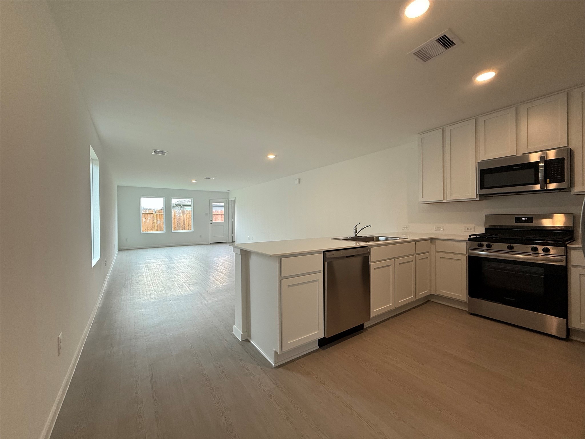 12915 Shells Lane Crosby, TX 77532 - Photo 9 of 20 a kitchen with granite countertop white cabinets and stainless steel appliances