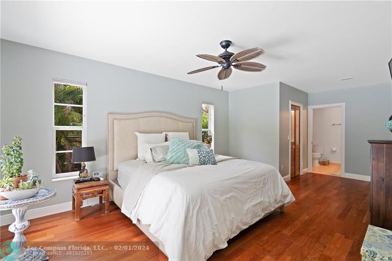 1129 Southwest 2nd Street Boca Raton, FL 33486 - Photo 14 of 39 a bedroom with a bed and a chandelier