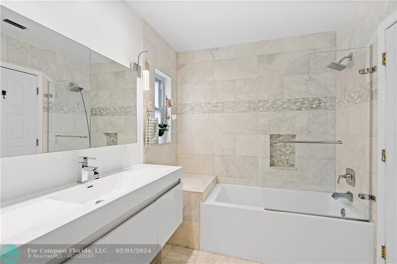 1129 Southwest 2nd Street Boca Raton, FL 33486 - Photo 15 of 39 a bathroom with a tub a sink and a shower