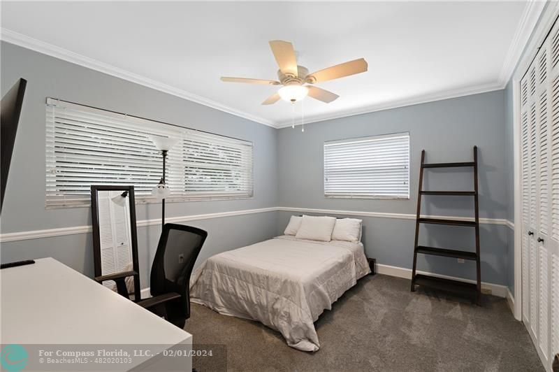 1129 Southwest 2nd Street Boca Raton, FL 33486 - Photo 18 of 39 a bedroom with two beds and a window