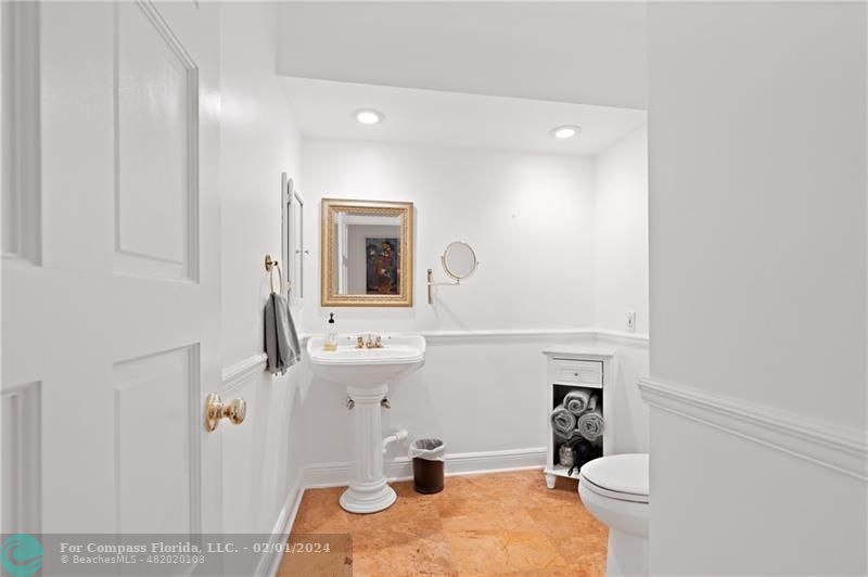 1129 Southwest 2nd Street Boca Raton, FL 33486 - Photo 20 of 39 a bathroom with a sink toilet and mirror