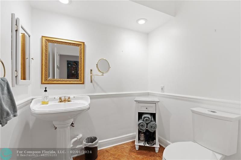 1129 Southwest 2nd Street Boca Raton, FL 33486 - Photo 21 of 39 a bathroom with a sink a toilet and a mirror