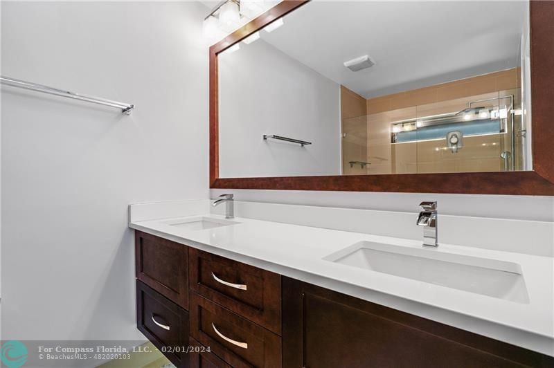 1129 Southwest 2nd Street Boca Raton, FL 33486 - Photo 22 of 39 a bathroom with a sink and a mirror