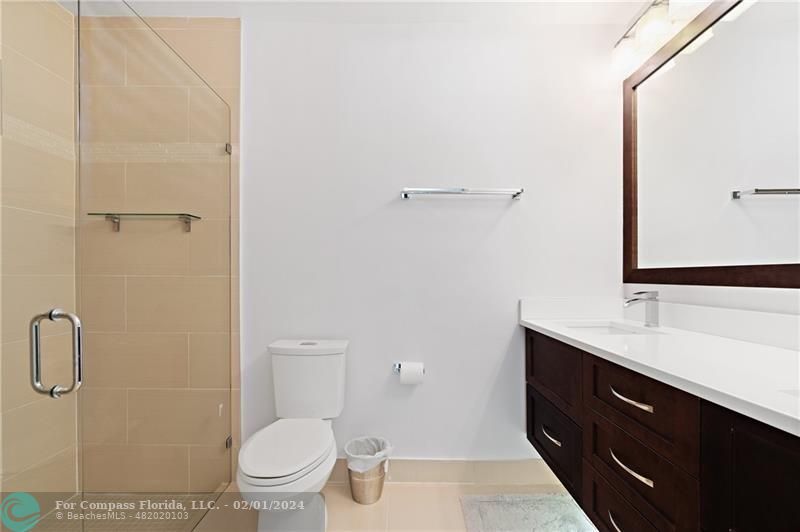 1129 Southwest 2nd Street Boca Raton, FL 33486 - Photo 23 of 39 a bathroom with a toilet a sink and mirror
