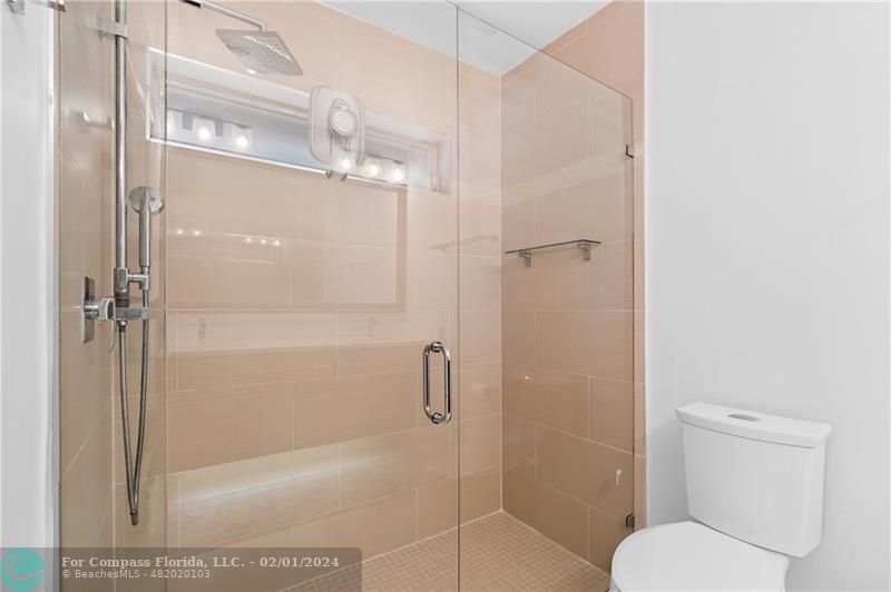 1129 Southwest 2nd Street Boca Raton, FL 33486 - Photo 24 of 39 a bathroom with a shower and toilet