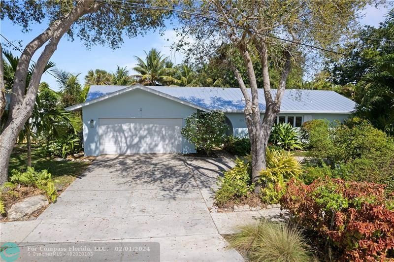 1129 Southwest 2nd Street Boca Raton, FL 33486 - Photo 27 of 39 a front view of a house with a garden