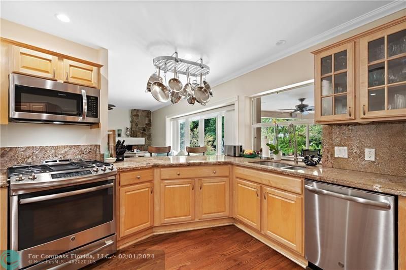 1129 Southwest 2nd Street Boca Raton, FL 33486 - Photo 3 of 39 a kitchen with a sink stove and microwave