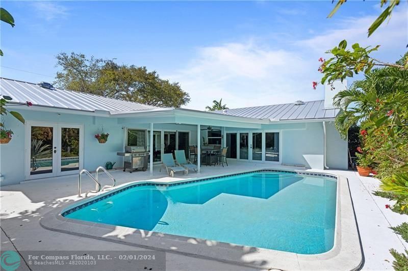 1129 Southwest 2nd Street Boca Raton, FL 33486 - Photo 34 of 39 a view of a house with swimming pool and sitting area