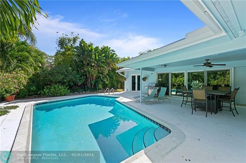 1129 Southwest 2nd Street Boca Raton, FL 33486 - Photo 35 of 39 a view of a swimming pool with chairs in patio