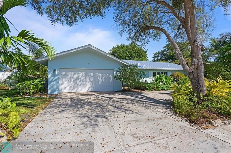 1129 Southwest 2nd Street Boca Raton, FL 33486 - Photo 37 of 39 a front view of a house with a yard and garage