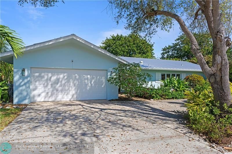 1129 Southwest 2nd Street Boca Raton, FL 33486 - Photo 38 of 39 a front view of a house with a yard and garage