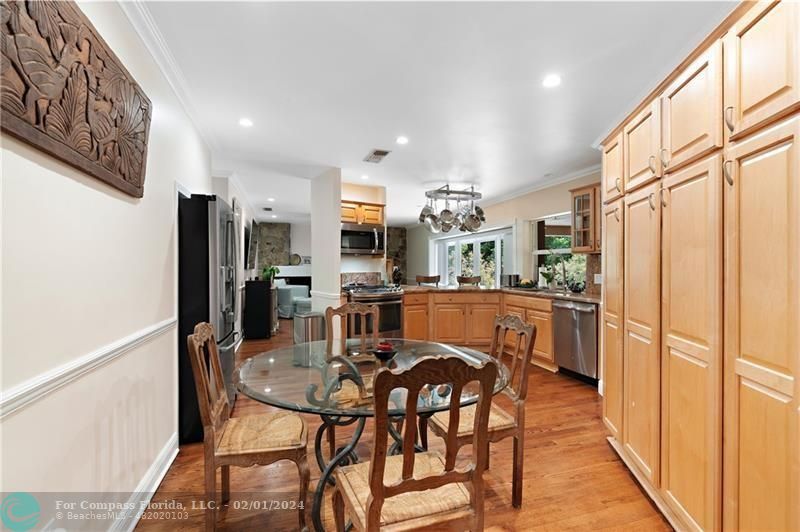 1129 Southwest 2nd Street Boca Raton, FL 33486 - Photo 5 of 39 a dining room with stainless steel appliances kitchen island granite countertop a refrigerator and microwave