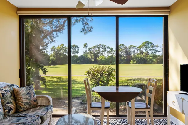 a view of a dining room with furniture wooden floor and chandelier
